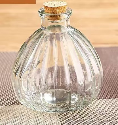 small glass bottle with cork